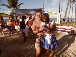 A tourist dances with local hospitality worker in the Dominican Republic