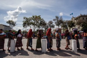This image shows the many indigenous women getting together to protest against the mining operations, in order  to protect their land, culture, and community residents.